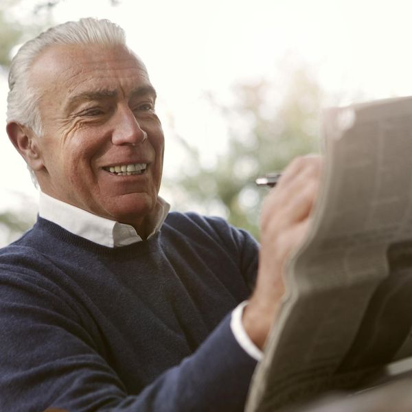 Smiling person enjoying a moment of peace outdoors in nature.
